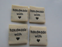 Load image into Gallery viewer, 100 Beige Handmade with (love) heart symbol woven flag labels 2 x 2cm