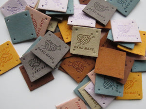 12 Mixed Colour Heart with wool wrapped around  it with knitting needles Hand made PU leather labels. 25 x 25mm