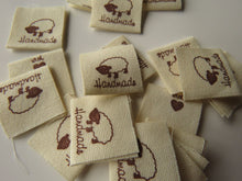 Load image into Gallery viewer, 25 Handmade with heart and Sheep Cotton Flag Labels 2 x 2cm folded