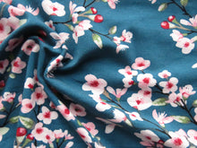 Load image into Gallery viewer, 1m Cherry blossom print on teal background 95% EcoVero viscose with stretch 150cm wide.