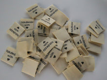Load image into Gallery viewer, 50 Beige Handmade with (love) heart symbol woven flag labels 2 x 2cm