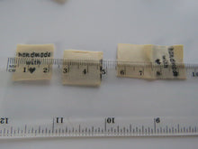 Load image into Gallery viewer, 50 Beige Handmade with (love) heart symbol woven flag labels 2 x 2cm