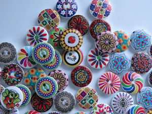 20 mixed print miscellaneous patterns. buttons 15mm 2 holes with white back.