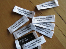 Load image into Gallery viewer, 50 White &quot;Made with New Zealand Merino Wool Fabric&quot; Woven labels 50mm x 10mm