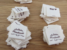 Load image into Gallery viewer, 25 Hand made between tiara  and  fancy scroll cotton flag labels. 2 x 2cm