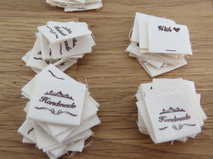 25 Hand made between tiara  and  fancy scroll cotton flag labels. 2 x 2cm