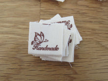 Load image into Gallery viewer, 50 Butterfly Hand made  with heart (love) cotton flag labels. 2 x 2cm