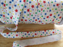 Load image into Gallery viewer, 1.7m Stars Blue Red Yellow Green on White FoldOver Elastic FOE Fold over elastic