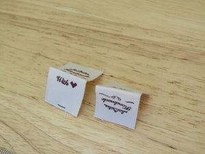 10 Hand made between tiara  and  fancy scroll cotton flag labels. 2 x 2cm