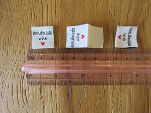 25 White Handmade with red heart 2 x 2cm satin flag shape labels