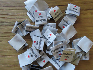 25 White Handmade with red heart 2 x 2cm satin flag shape labels