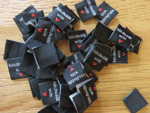 Load image into Gallery viewer, 50 Black Handmade with red heart 2 x 2cm satin flag labels.